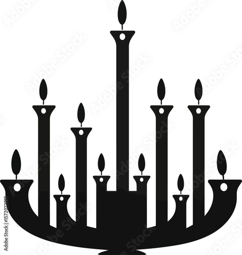Dark silhouette of an ornate chandelier with many candles offering elegant lighting and ambiance for a stately home or event.
