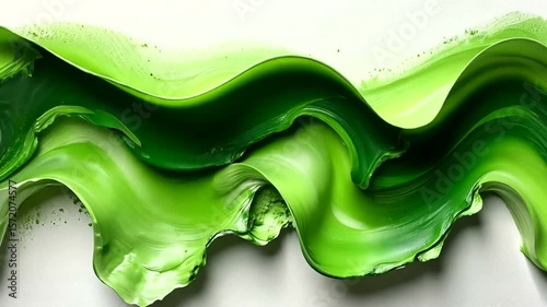 Vibrant green fluid waves on a white surface creating an abstract and dynamic background