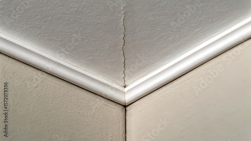 Cracks in ceiling corner highlight foundation problem that can affect structural integrity of home