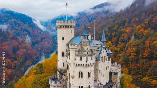 Majestic castle on a hill surrounded by colorful autumn trees in a scenic landscape