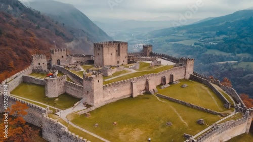 Stunning aerial view of an ancient castle surrounded by autumn landscape in the mountains