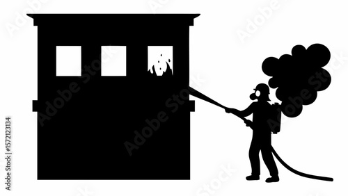 Silhouette of firefighter extinguishing a burning building with a hose and smoke in the background