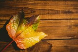 Wooden table with autumn leaves