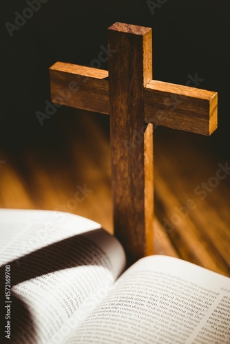 Shadow of wooden cross falling on bible