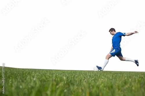 Football player kicking ball