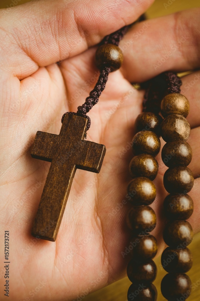 Naklejka premium Hand holding rosary beads