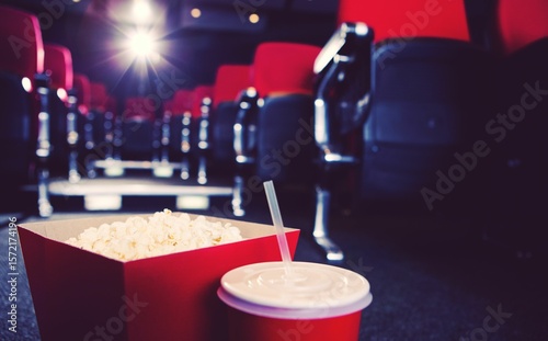 Popcorn box with drink in theater