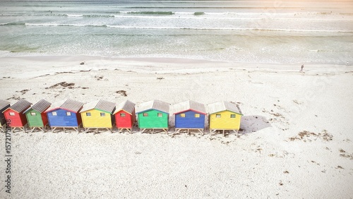 Multi colored wooden huts by mountain at beach