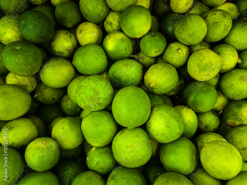 Green lime Fresh ripe juicy limes as background.
