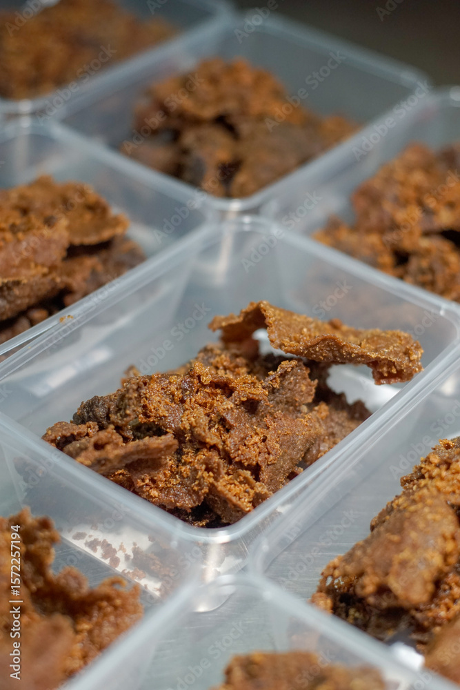 Close up of golden brown, crispy beef pieces packed in clear plastic containers Close up of golden brown, crispy beef pieces packed in clear plastic containers