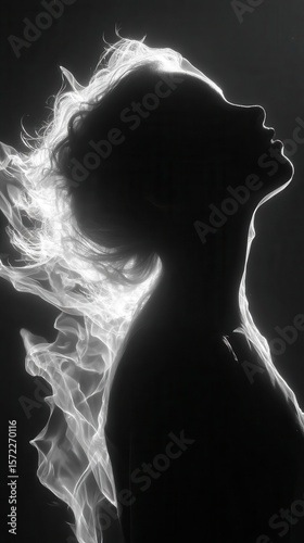Silhouette of a woman with ethereal, fiery hair.