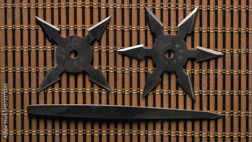 Ancient ninja weapons of the throwing type. Close-up of Ninja Star Shurikens with Bo Shuriken on Wooden Background.