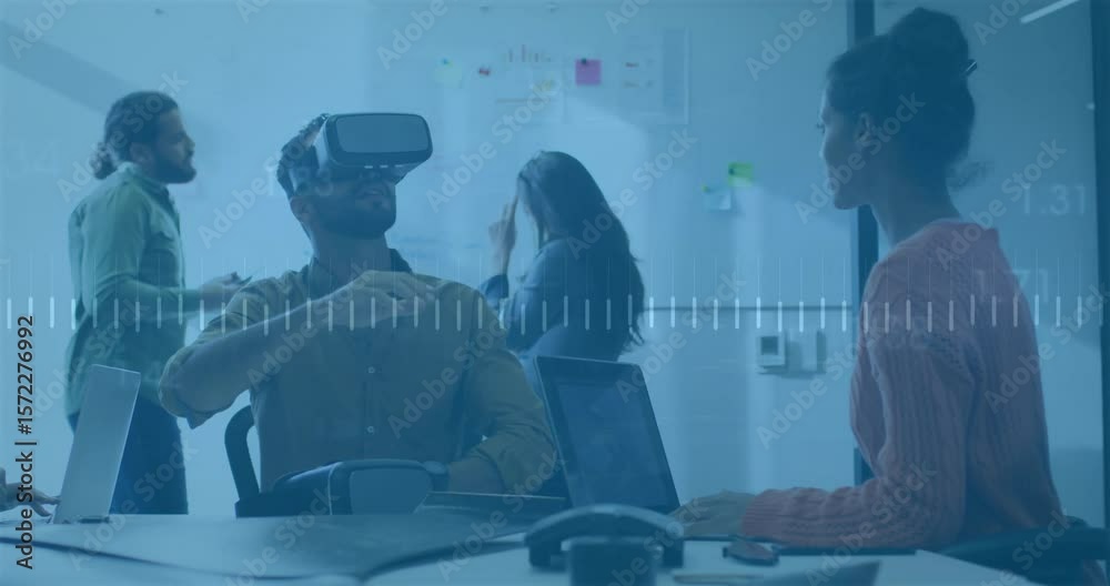 Mid adult man putting on VR headset initiating demo while colleague guiding controls with waveform