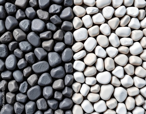 the image features a close up, overhead position filled with natural stones or pebbles, these elements are arranged in a deliberate manner, split roughly in half