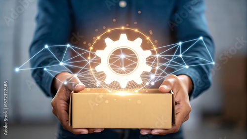 Hands holding a gear emerging from a box connected by a network image