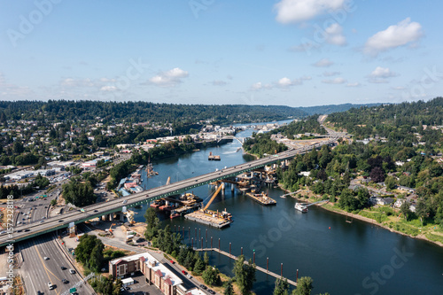 Aerial drone picture of Abernethy Bridge and I-205 highway over the Willamette River, connecting Oregon City and West Linn, Oregon, with construction barges, traffic, and scenic surroundings	
