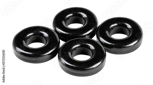 Black glossy chewy candy rings with smooth surface and shiny texture