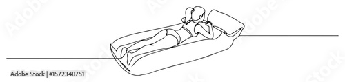 woman relaxing on inflatable mattress in water