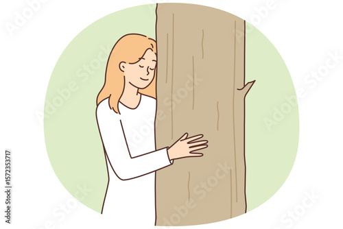 Teenage girl caringly hugging tree cuddling up to plant for concept of caring for nature
