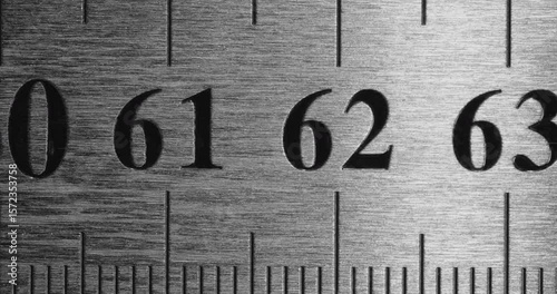 Metal Ruler Close-Up. Video featuring a detailed view of a sleek metal ruler with precise millimeter markings, captured in high clarity.