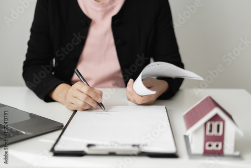 cagents working in real estate investment and home insurance signing contracts in accordance with the home buying insurance agreements approving purchases for clients