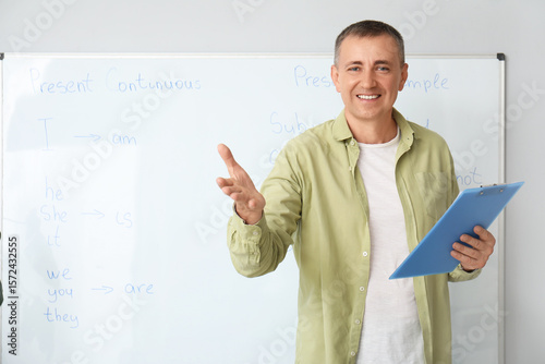 Male teacher with clipboard...