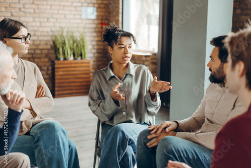 Wall Mural African American woman leading group therapy session for mental health
