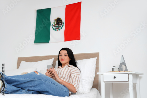 Young Mexican woman using m...