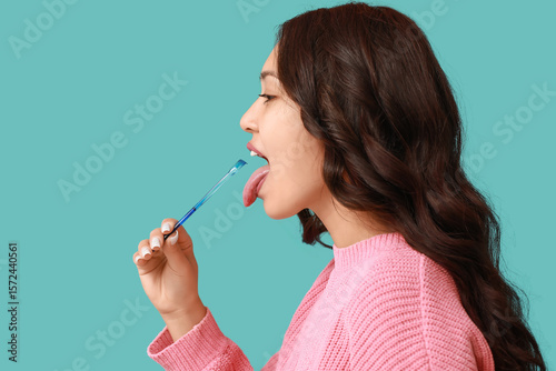 Young Asian woman with tong...