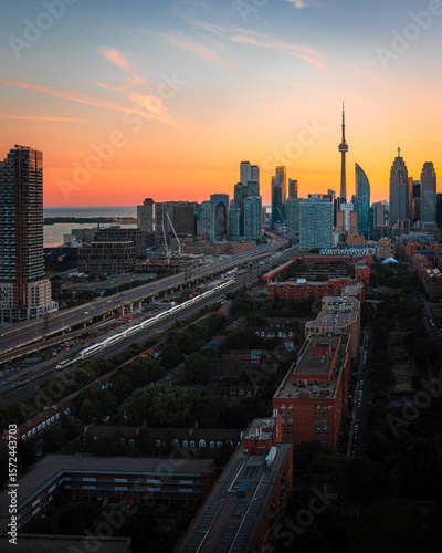 Wallpaper Mural Entire futuristic sunset city skyline view of downtown Toronto Canada. Modern buildings, urban architecture, cars travelling. construction and development in a busy city	 Torontodigital.ca