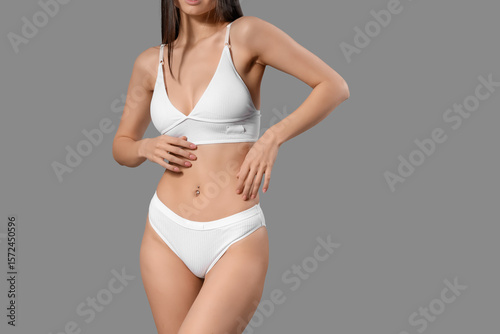 Slim young woman in white c...