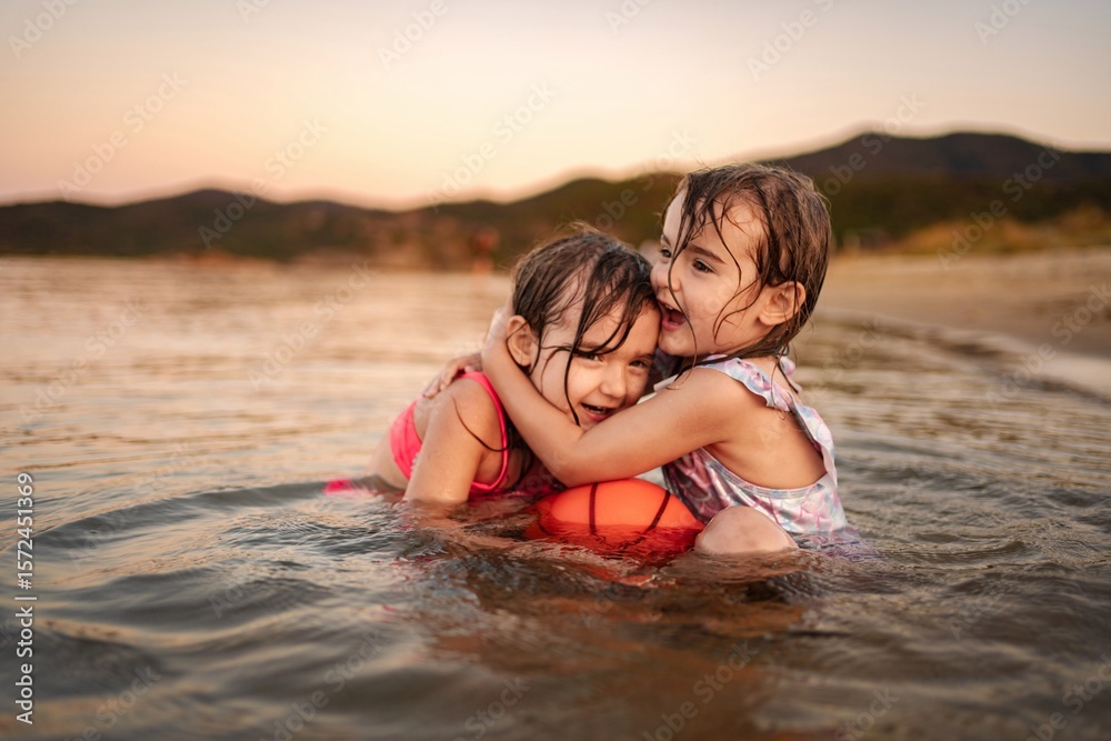 Sisters enjoy playful moments at the beach during sunset Sisters enjoy playful moments at the beach during sunset