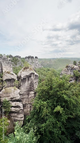 Vertical video, Saxon Switzerland National Park, rocky terrain valley, ugc landscape from height, stone mountains, hills and forest serenity.