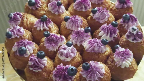 Pastries with cream and berries, beautifully arranged on a tray for an appetizing display
