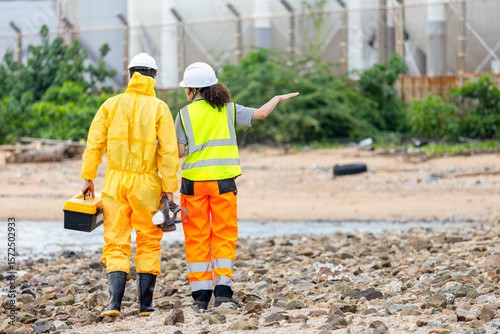 Back View of Researchers Testing Water Quality at a Lake or Coastal Area, Environmental Scientists Collecting Water Samples for Analysis, Water Pollution Control, Scientists at Work in the Field