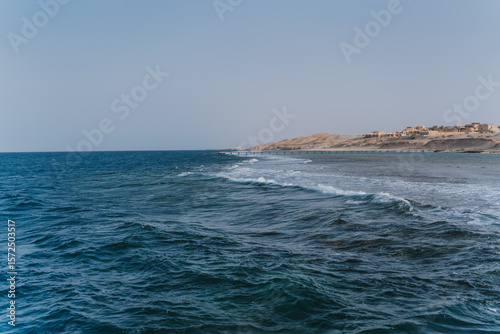 Fototapeta Naklejka Na Ścianę i Meble -  Deep blue ocean waves crashing on sandy beach in egypt