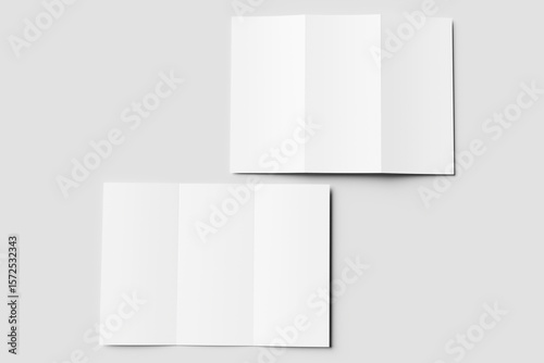 Two blank white tri-fold brochure mockups. One partially open, one closed, on a light gray surface. Ideal for design presentations or branding.