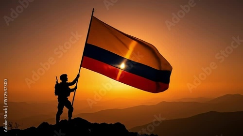 Colombia Independence Day Military Person Silhouetted Holding Waving Flag on Mountain Top at Dramatic Sunset