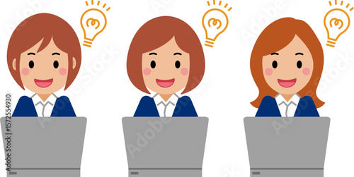 ひらめき顔でパソコンを操作する紺色スーツの若い女性