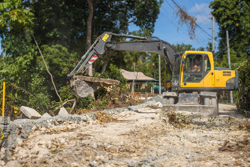 Obraz premium dismantling, reconstruction of a concrete highway by an excavator
