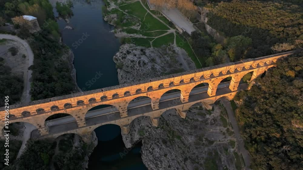 Aerial view of massive Roman aqueduct Pont du Gard spanning river in France