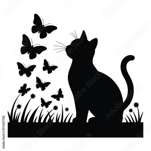 Cute cat sitting in a field, gazing at a group of butterflies