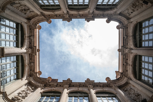 Looking up from a classic and luxurious building courtyard.