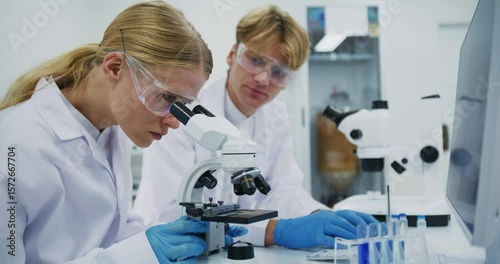 Scientists Analyzing Samples with Microscopes in Modern Lab