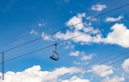 Empty and unoccupied ski lift, Swiss Alps. Switzerland, Canton St. Gallen. Clear sky with clouds, summer. Hiking, traveling, tourism, destination, recreation, leisure activity.