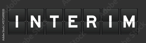 Black color analog flip board with word interim on gray background