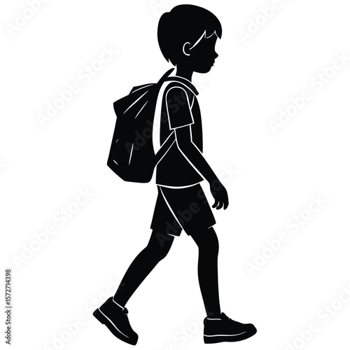 Silhouette of a schoolboy walking side view with backpack