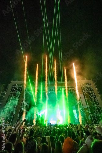 Crowd enjoying spectacular fireworks and laser show at music festival