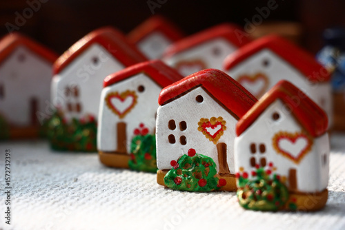 Toy village. Small lodges from clay with bright festive registration. Picture of happiness and love.