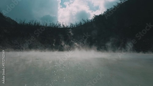Serene Steaming Lake in Rugged Mountains